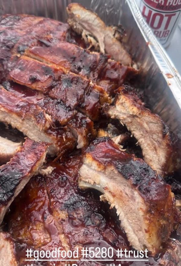 A full catering pan of sauced, sliced ribs